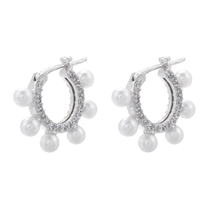 Detail of silver C-shape earrings with pearls and zircon stones in a retro French style