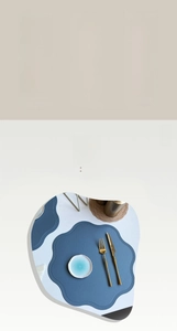 Detail of blue faux leather place mat with lychee texture and heat resistant features