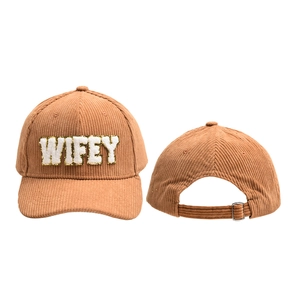 Detail of WIFEY chenille letter patch on brown corduroy baseball cap with gold glitter