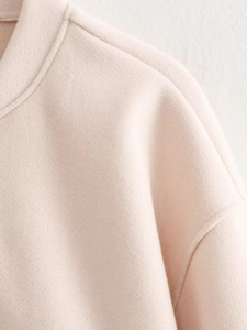 Detailed close-up showing the drop shoulder seams and ribbed neckline of the warm fleece jacket