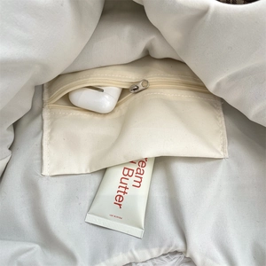 Detail of inner pocket with metal zipper and storage for small personal essentials