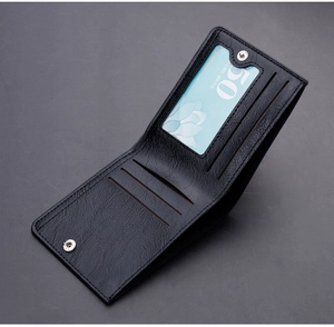 Macro view of black bifold leather wallet with card slots and snap button closure