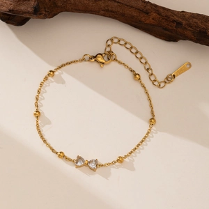 Elegant gold-plated stainless steel bow bracelet with heart-shaped zircon stones