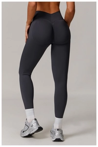 Detail of high waisted yoga pants in dark grey featuring scrunch butt lifting design