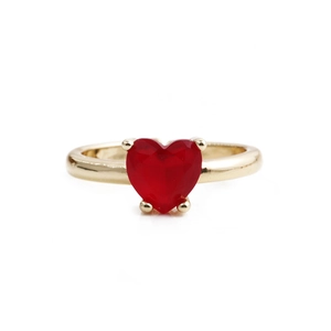 Minimalist gold ring featuring a heart-shaped red gemstone on a plain white background