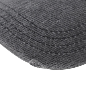 Detailed macro view of distressed brim on washed cotton baseball cap with stitch lines