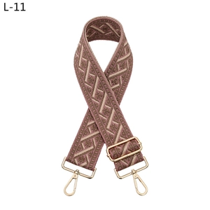 Macro view of vintage jacquard strap in pink and brown with gold metal lobster clasps