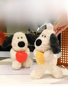 Detail of plush dog toys with red LOVE heart and yellow bread accessory on a desk