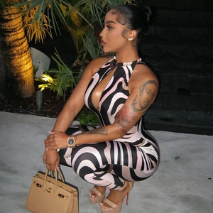 Slim fit halter cutout jumpsuit with pink zebra stripe print in a wave pattern