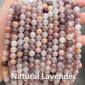 Macro shot of natural violet stone beads showing smooth texture and unique mineral patterns