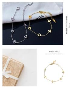 Detail of gold and silver heart-shaped stainless steel bracelets with lobster clasp