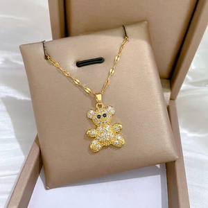 Elegant gold bear pendant necklace with sparkling crystals and star detail on silk base