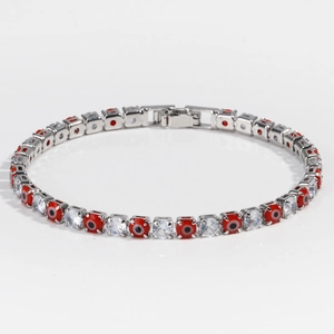 Detail of silver tennis chain with red evil eye charms and 4mm cubic zirconia stones