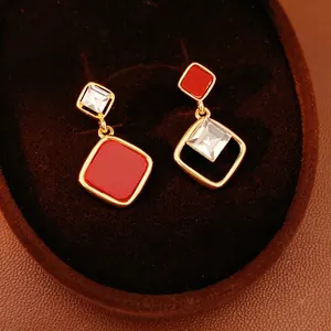 Asymmetric 18k gold plated diamond-shaped stud earrings with red and zircon stones