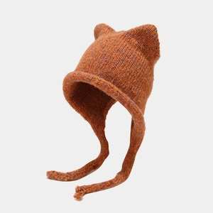 Winter knit cat ear hat with earflaps and long tassels in warm caramel orange color