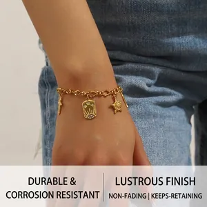 Detailed close-up of 18K gold-plated stainless steel bracelet with vintage pendants