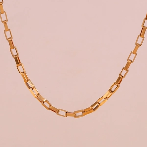 Close-up of a 18K gold plated stainless steel paperclip chain on a soft pink background