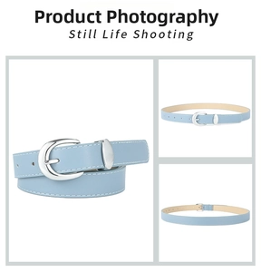 Detail of light blue PU leather belt with silver oval buckle and white stitching