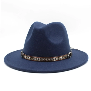 Detail of dark blue fedora with ethnic woven band and metallic buckle on flat brim