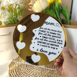 Detail of golden acrylic Mother's Day plaque with five heart-shaped photo frames