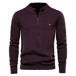 Macro detail of men's knitted zip cardigan collar in burgundy with premium textured fabric