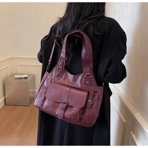 Professional model wearing a vintage burgundy PU leather tote bag with adjustable shoulder strap