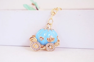 Detailed view of light blue enamel pumpkin carriage keychain with sparkling white rhinestones