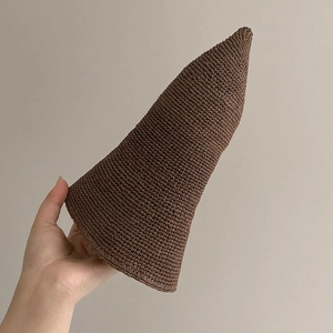 Handmade crochet sun hat with a pointed crown in deep brown woven straw texture