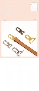 Macro shot of detachable metal hooks in gold and silver with a brown leather shoulder strap