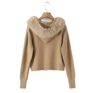 Detail of apricot knit sweater featuring a fluffy faux fur collar and zip closure back