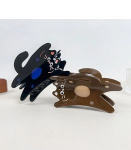 Macro detail of cute cat acetate hair claws in black and brown with glossy finish