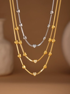 Detailed view of layered 18k gold plated heart necklaces with sparkling zircons