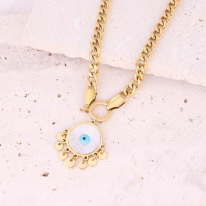 Golden stainless steel evil eye pendant necklace with dangling charms on stone surface