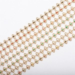Macro detail of 18K gold plated chains with multi-color enamel evil eye charms for jewelry