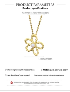 Detail of gold floral necklace featuring textured petals with a central pearl inlay
