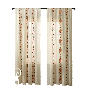 Christmas tablecloth with red bell embroidery and lace trim on a white background