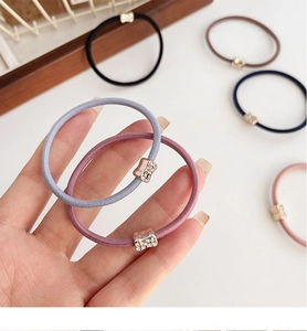 Close-up of elastic hair bands in assorted colors featuring decorative metal buckles