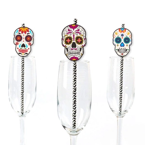 Close-up of Day of the Dead paper straws with colorful sugar skull designs in glassware