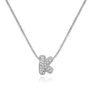 Detailed macro shot of silver bubble letter K pendant with cubic zirconia on necklace