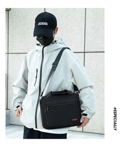 Detail of black business briefcase featuring water-resistant fabric and shoulder strap