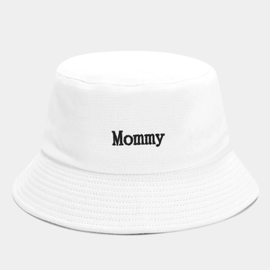 White cotton bucket hat featuring minimalist black Mommy embroidery on a clean background