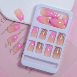 Pink gradient press-on nails with gold glitter sequins in long coffin shape design