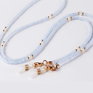 Detailed macro of light blue beads and white pearls on a multifunctional eyeglass chain