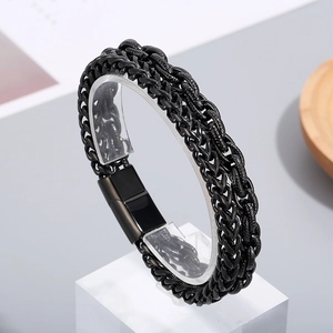 Detail of black double-row braided steel bracelet for men with magnetic clasp