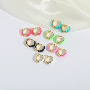 Close-up of colorful enamel hoop earrings in gold finish featuring various vibrant shades