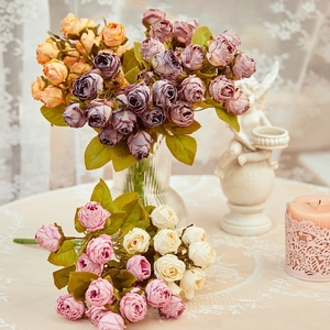 Artificial vintage rose bouquet in a glass vase for elegant home floral decoration