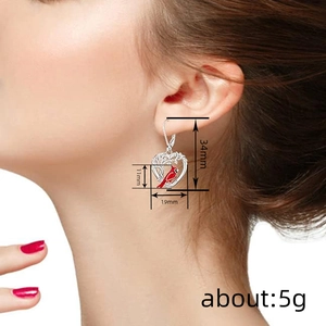 Chinese style heart-shaped bird earrings with intricate hollow branch pattern and red cardinal