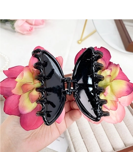 Detail of pink and yellow 3D flower hair claw clip with strong spring and grip teeth