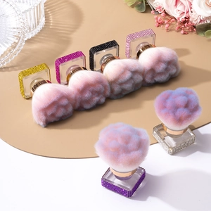 Close-up of luxury rhinestone handle makeup brushes with colorful fluffy heads