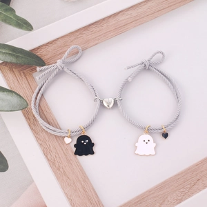 Matching magnetic couple bracelets featuring cute ghost charms and grey braided rope